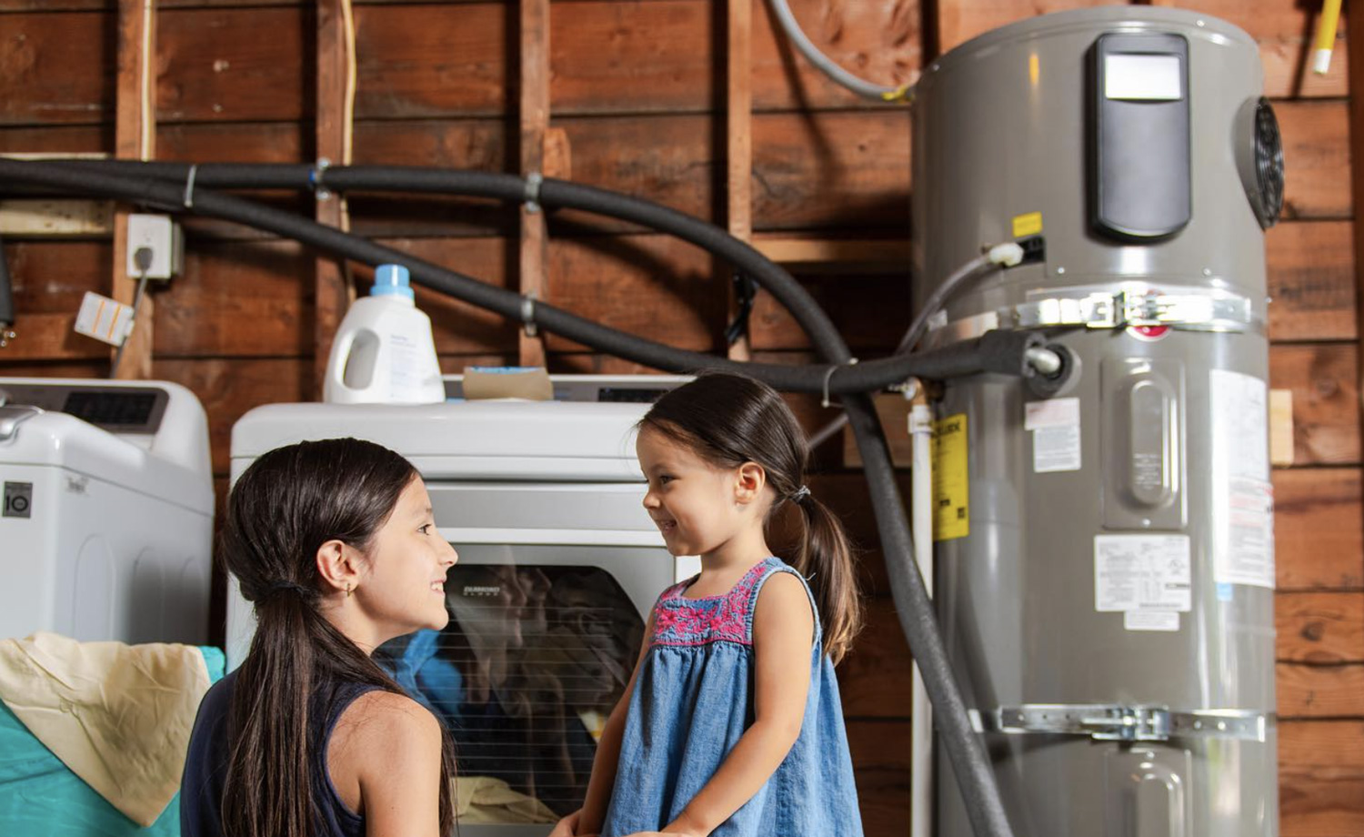 Mother and daughter in a garage doing laundry