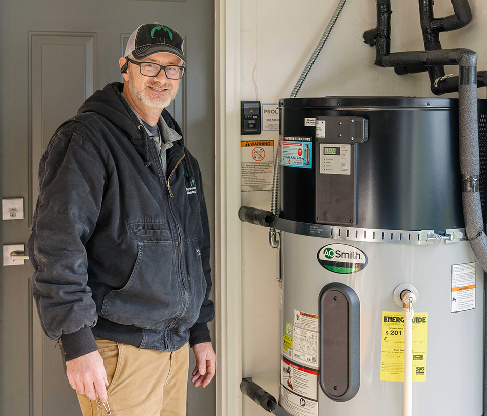 Technician standing by water heater